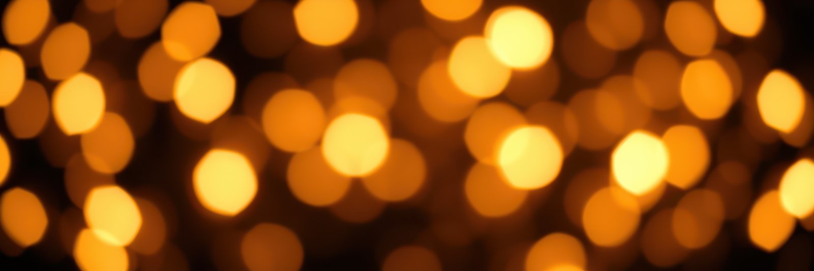 Bright golden bokeh lights creating a warm and festive atmosphere during a celebratory evening event